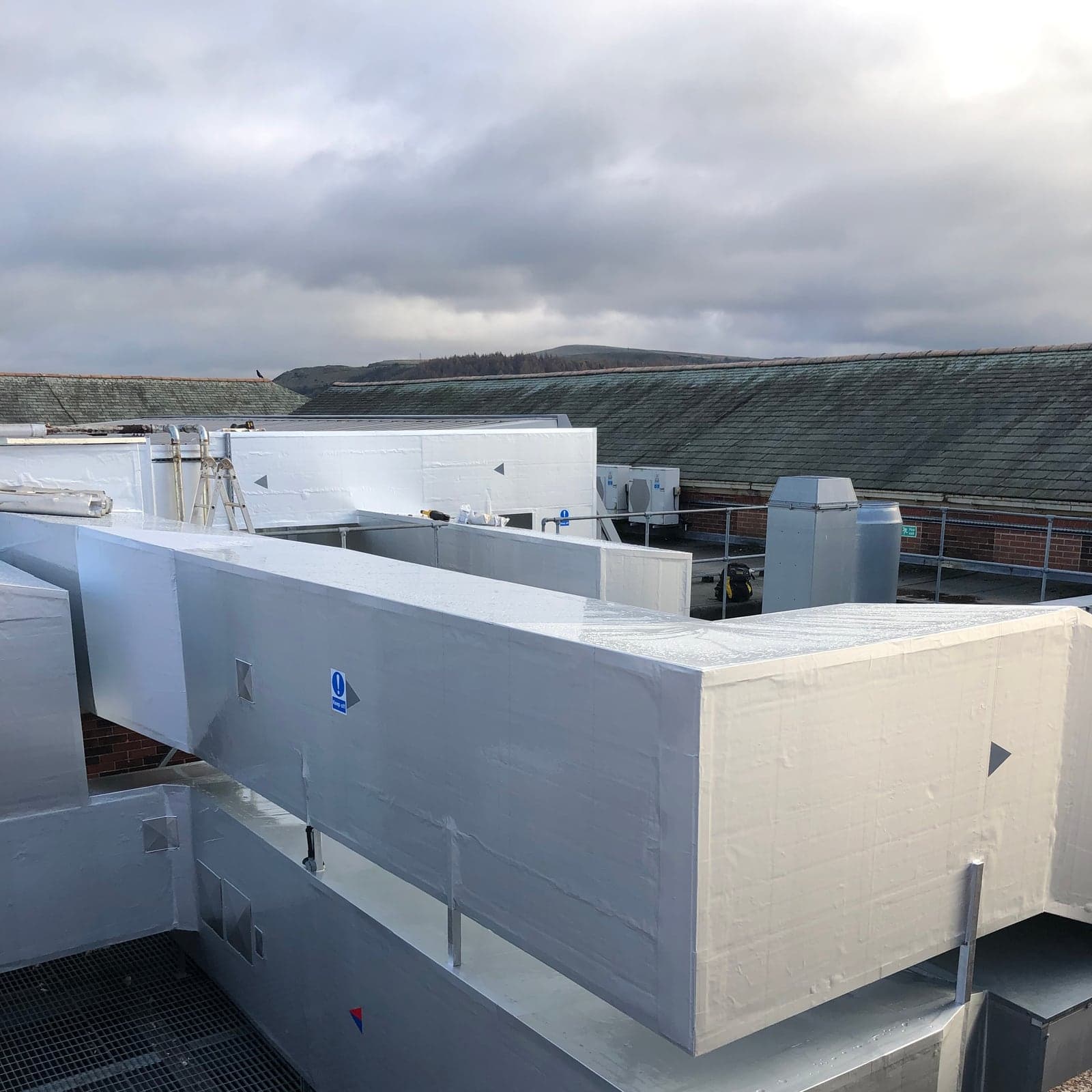 External cladding and rooftop riser pipework